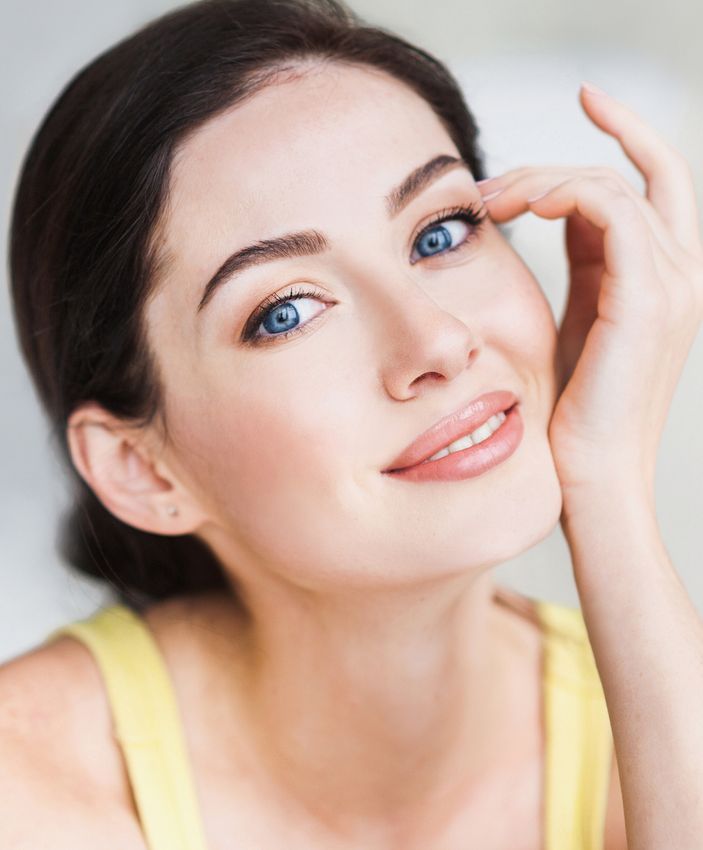 Lomita dermal fillers model with captivating blue eyes gazing directly at the camera
