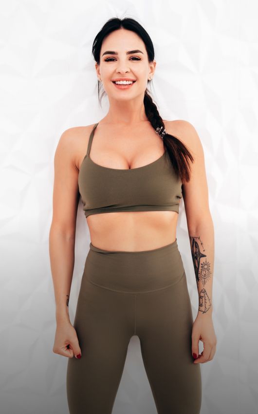  South Bay med spa model wearing a brown sports bra top and leggings