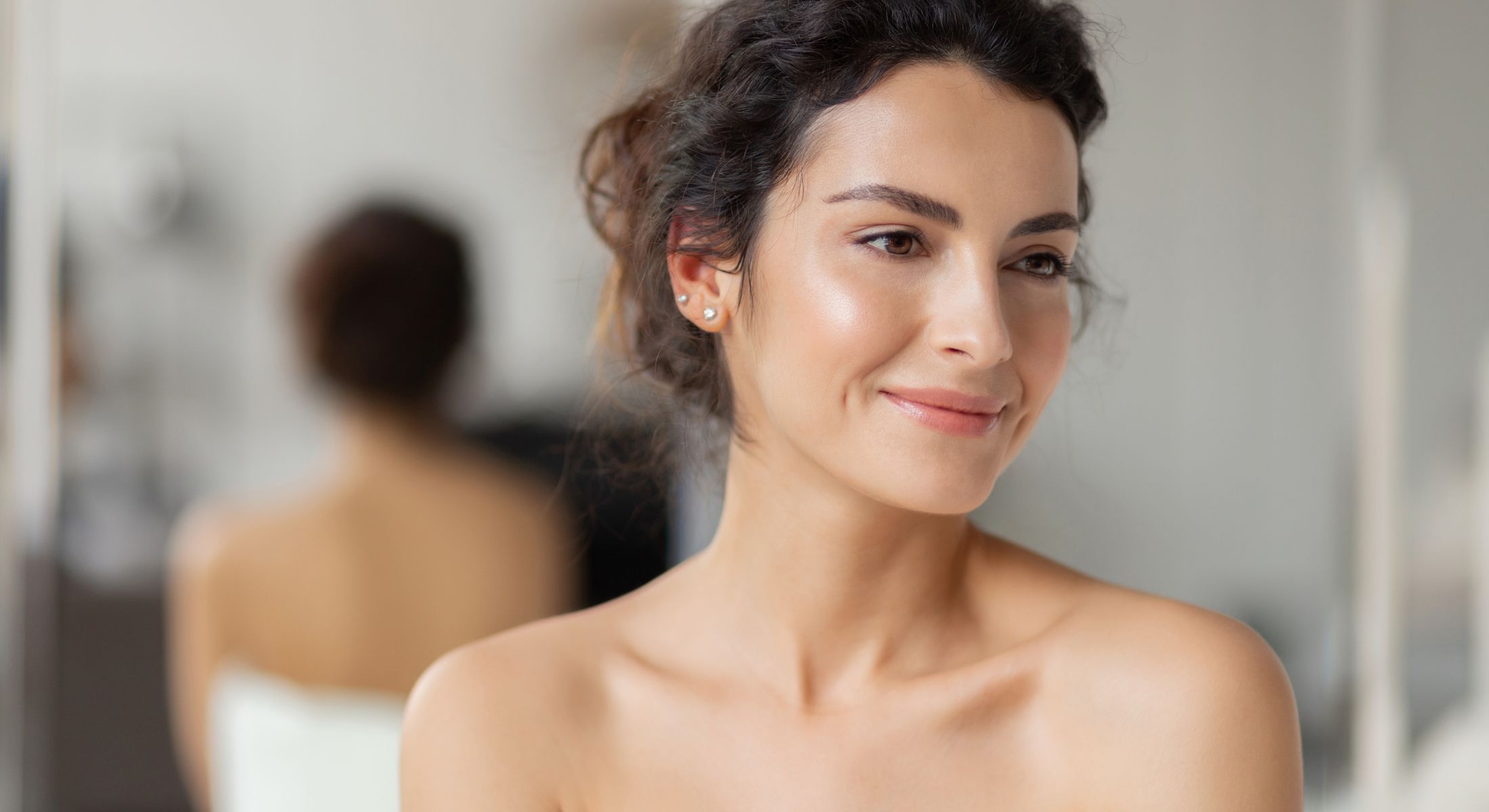 Torrance laser hair removal model smiling in mirror