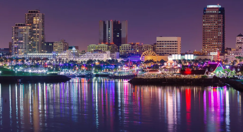 Vibrant city skyline at night, illuminated with colorful lights