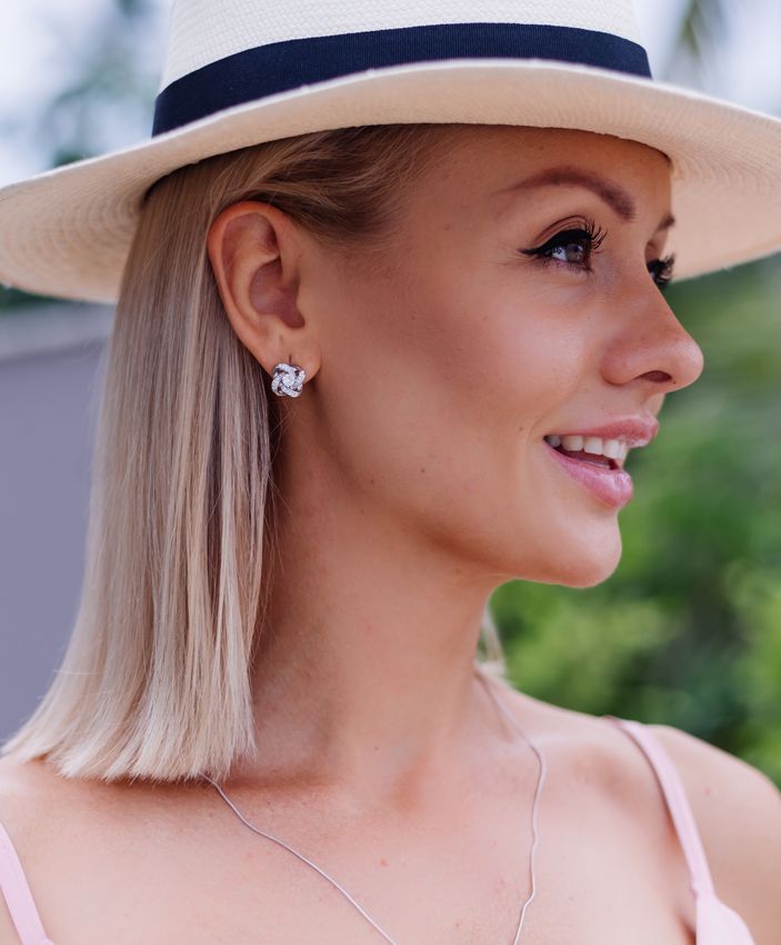 Lomita botox model wearing a hat and necklace, looking stylish and elegant